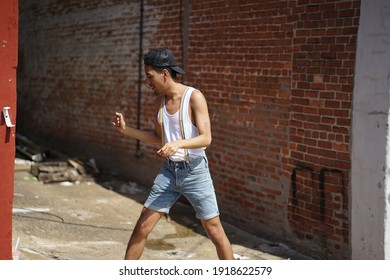 Baltimore, Maryland - USA - June 15, 2019: Gay Pride Downtown Baltimore. Portrait Of A Young Latino Brown Male Posing With Short, White T-shirt And Rainbow Suspenders In An Alley.