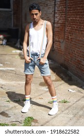 Baltimore, Maryland - USA - June 15, 2019: Gay Pride Downtown Baltimore. Portrait Of A Young Latino Brown Male Posing With Short, White T-shirt And Rainbow Suspenders In An Alley.