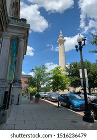 
Baltimore, MD / US - June 22 2019: The Washington Monument Of Baltimore As Seen From The Hopkins Peabody Institute On Mount Vernon Park Historic District