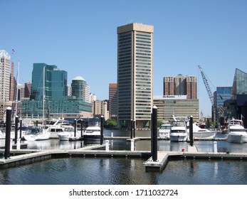 Baltimore, MD / USA - April 25, 2012: Baltimore's City Skyline Overlooks The Nearly Empty Inner Harbor Marina.       