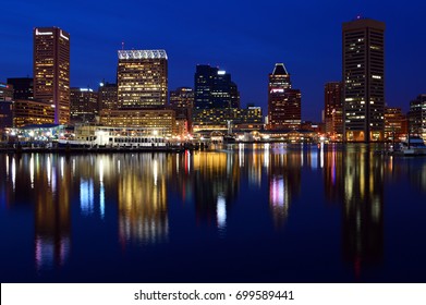 Baltimore, MD, USA March 28 The Skyline Of Baltimore Maryland Is Reflected In The Waters Of Inner Harbor