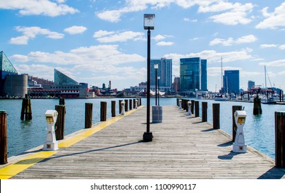 Baltimore, MD/USA - 4/8/2018: View From A Wooden Pier Of The Modern Skyline At Baltimore's Inner Harbor On A Sunny Day