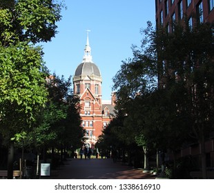 Baltimore, Md./USA-Oct. 17, 2017: People Walk Across The Campus Of Johns Hopkins University Toward The Domed Building Of The School Of Medicine.                                