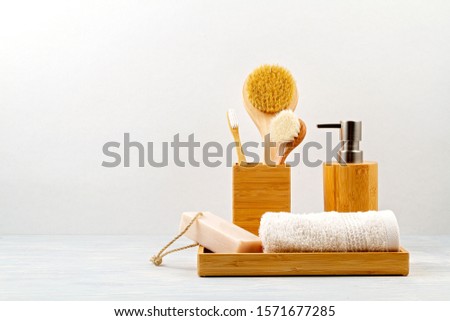 Bamboo acessories for bath - bowl, soap dispenser, brushes, tooth brush, towel and organic dry shampoo for personal hygiene. Zero waste, plastic free, sustainable decor for bathroom interior