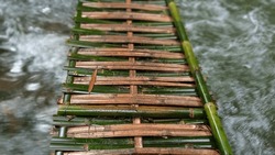 Bamboo Bridge Over A Flowing River