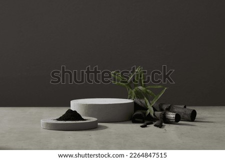 Bamboo charcoal and activated bamboo powder are ingredients of many cosmetics, with many uses. Empty podium to display products, goods. Front view.