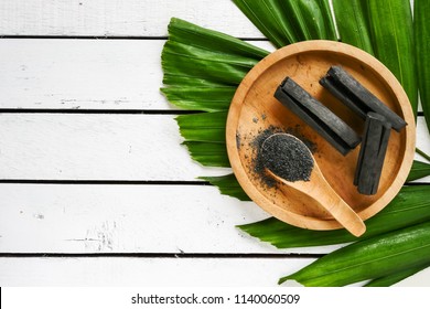 Bamboo charcoal and powder on wooden table. copy space