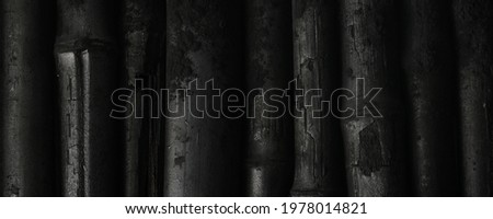 Bamboo charcoal  sticks on coal powder black background.
Powerful water purifier 