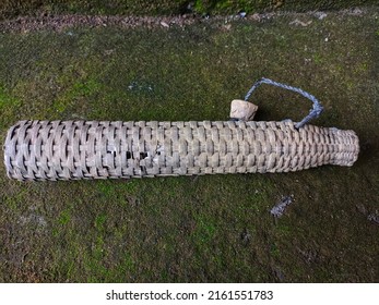 The Bamboo Eel Trap Is On The Mossy Floor, Photographed Horizontally.