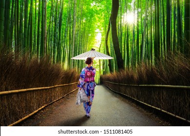 Bamboo forest at Arashiyama with woman in traditional kinono and umbrella. Japan - Powered by Shutterstock