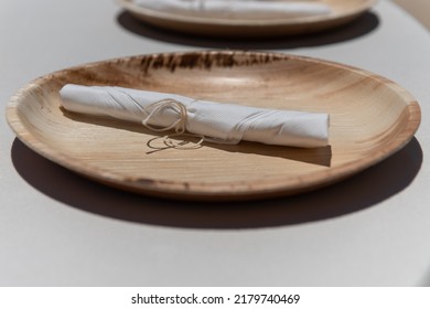 Bamboo Plates And Untensils Wrapped In A Paper Napkin Is For Each Dinner Guest To Use At The Meal.