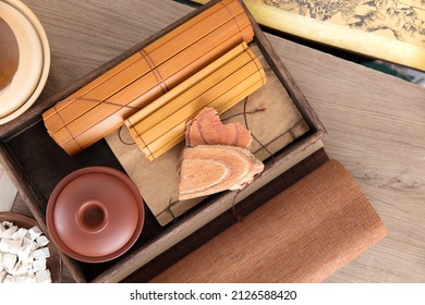 Bamboo Slips Medical Books And Caulis Spatholobi Medicinal Materials In A Wooden Tray