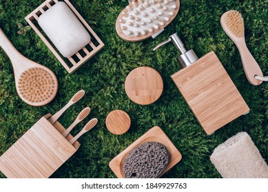 Bamboo Spa And Bath Accessories, Soap Dish, Dispenser, Tooth Brush, Organic Dry Shampoo For Personal Hygiene On Green Moss Texture. Copy Space. Top View. Zero Waste, Plastic Free, Sustainable Concept.