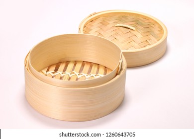 Bamboo steamer with open lid isolated on white background 