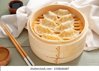Bamboo steamer with tasty Japanese gyoza on table