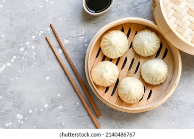  Bamboo Steamers With Tasty Baozi Dumplings, Chopsticks And Bowl Of Sauce. Chinese Food Delivery