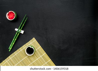 Bamboo Sticks, Soy Sauce, Ginger For Sushi And Maki On Black Background Top View Mockup