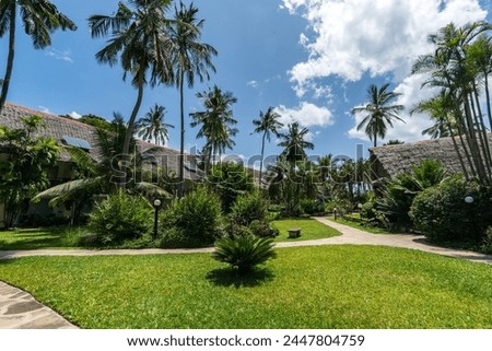 Bamboo Straws and sticks roof huts tropical village bungalow houses resort palm trees on a sunny day Ecotourism