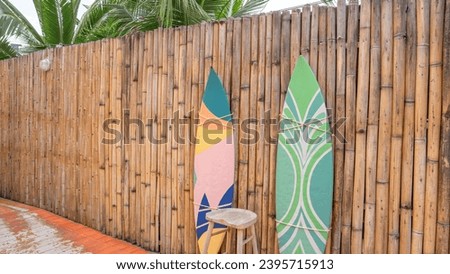 A bamboo wall separates the path. Arranged close together, decorated with a beach concept, using bright colors. You can see the green trees in the background, it's natural. Can be used as an illustrat Stock photo © 