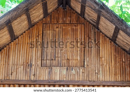 Bamboo wall and window made out of bamboo sticks and nipa roofing from a Philippine bahay kubo