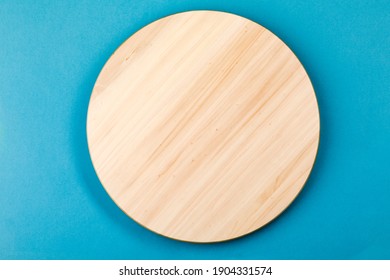 Bamboo or wooden rotating tray, on a blue background - Shutterstock ID 1904331574