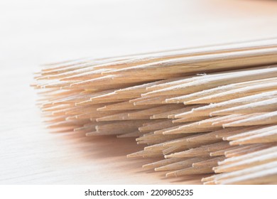 Bamboo Wooden Skewers Closeup Soft Focus On Natural White Background. Kitchen Utencil.