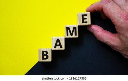 BAME symbol. Abbreviation BAME, black, asian and minority ethnic on wooden cubes. Beautiful yellow and black background. Copy space. Business and BAME, black, asian and minority ethnic concept.