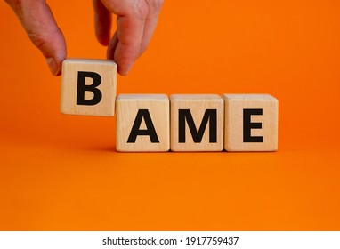 BAME symbol. Abbreviation BAME, black, asian and minority ethnic on wooden cubes. Beautiful orange background. Copy space. Business and BAME, black, asian and minority ethnic concept.