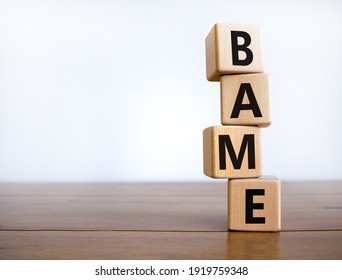 BAME symbol. Abbreviation BAME, black, asian and minority ethnic on wooden cubes. Beautiful wooden table, white background. Copy space. Business and BAME, black, asian and minority ethnic concept.