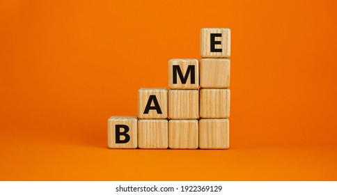 BAME Symbol. Abbreviation BAME, Black, Asian And Minority Ethnic On Wooden Cubes. Beautiful Orange Background. Copy Space. Business And BAME, Black, Asian And Minority Ethnic Concept.