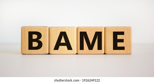 BAME symbol. Abbreviation BAME, black, asian and minority ethnic on wooden cubes. Beautiful white background. Copy space. Business and BAME, black, asian and minority ethnic concept.