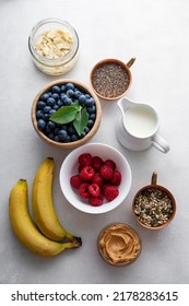 Banana And Berry Smoothie Ingredients Made From Fresh Banana, Blueberry, Raspberry, Milk, Peanut Butter, Chia Seeds, Almond Flakes.