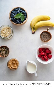 Banana And Berry Smoothie Ingredients Made From Fresh Banana, Blueberry, Raspberry, Milk, Peanut Butter, Chia Seeds, Almond Flakes. Top View, Copy Space