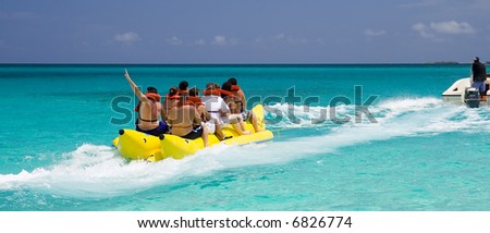 A Banana Boat Full of Tourists Speeding Away