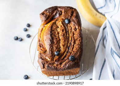 Banana Bread With Blueberries On A Cooling Rack On A Gray Background. Overhead View.