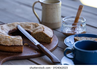 Banana Bread With Coffee Tea And Sweet Marmalade Jam And Knife On Wooden Table Outdoors Breakfast