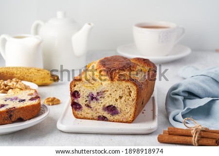 Banana bread, sliced cake with banana and blueberries. Morning breakfast with tea on light gray cincrete background Stock photo © 