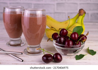 Banana And Cherry Chocolate Smoothie In Tall Glasses.