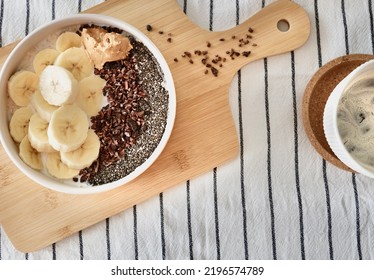 With Banana, Chia Seeds, Cocoa Beans. E Peanut Butter Porridge. With Iced Coffee. Breakfast. Overhead And Close-up.