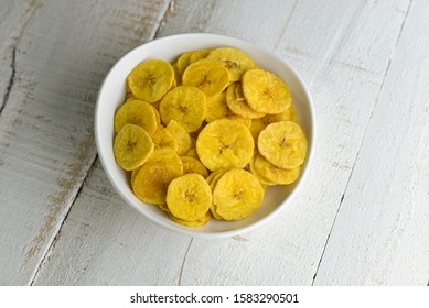 Banana chips or Kaya Varuthathu Kerala fried snacks on white background. popular in South India Tamil Nadu, Top view of Indian tea time food fried in coconut oil.
