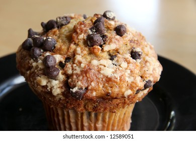 Banana And Chocolate Chip Muffin On Black Plate