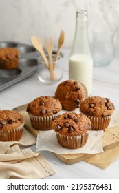 Banana Chocolate Chip Muffin On Wood And Bottle Milk On White Background