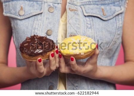 banana and chocolate donuts in the girl's hands