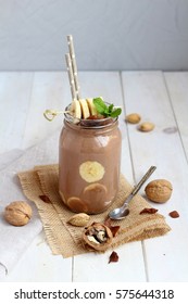 Banana chocolate smoothie with nuts and mint leaf