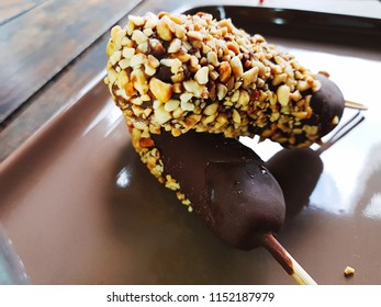 Banana Covered With Chocolate And Peanuts.