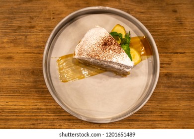 Banana Crape Cake With Coffee Powder And Mango Jame On Table.