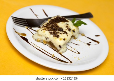 Banana And Cream Dessert. Cake On White Plate