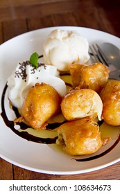 Banana Fritter With Vanilla Ice Cream And Whipcream And Chocolate Sauce