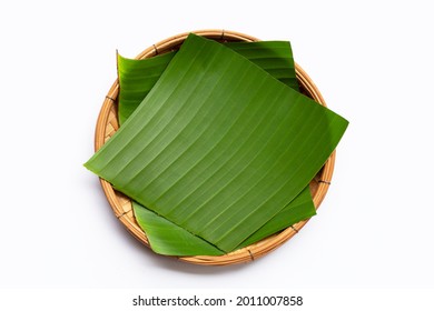 Banana leaves in bamboo basket on white background.