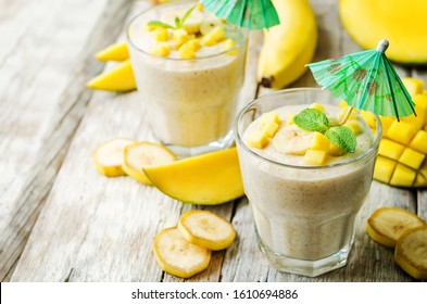 Banana Mango Smoothie On A Wood Background. Toning. Selective Focus